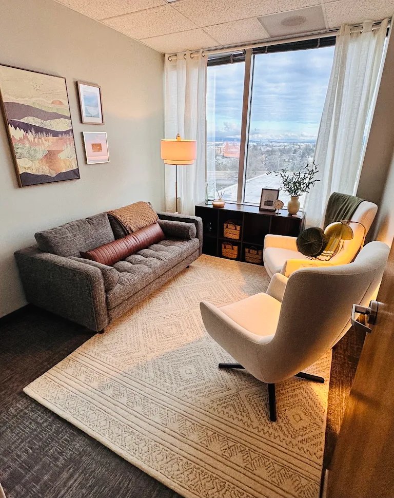 Office with gray sofa, sage pillows and landscape art